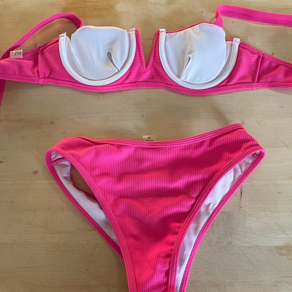 Brand new with tags hot pink bikini top is size small, bottoms are size medium